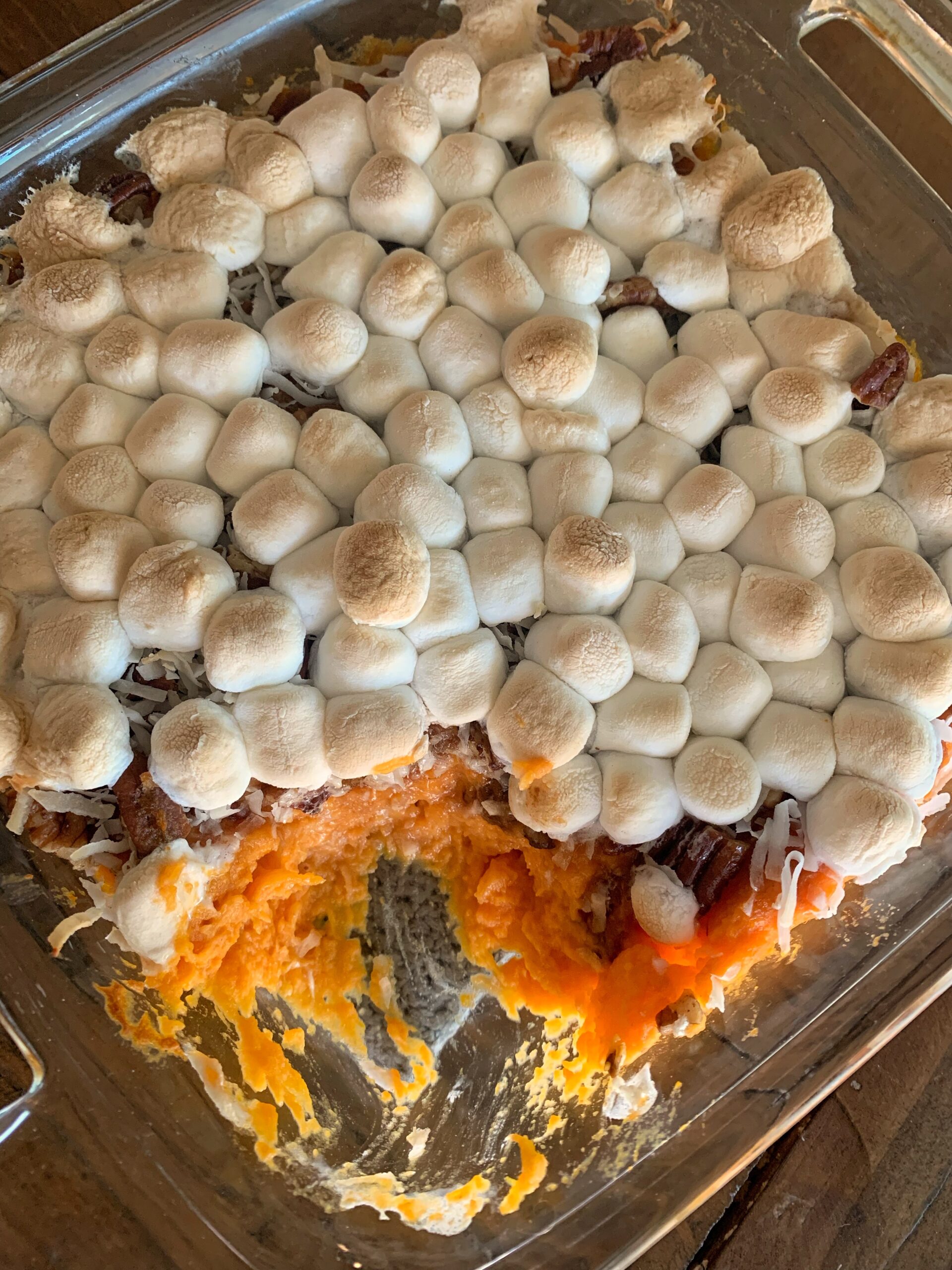 marshmallow topped sweet potato casserole in glass dish